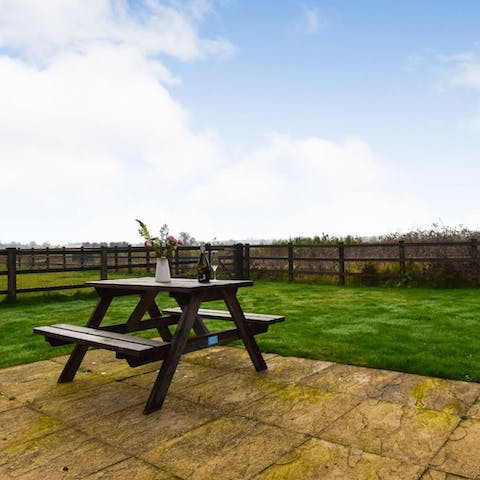 Perch at the picnic table with a cup of tea as the kids play in the garden