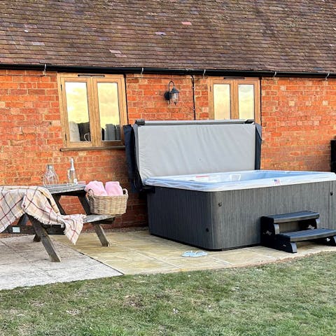 Relax and unwind under the sun in the private hot tub