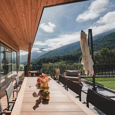 Dine alfresco with sweeping Alpine valley views stretching to the horizon