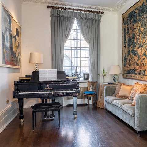 Tap out a tune on the grand piano in the dining room
