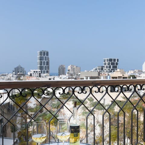Enjoy a crisp glass of locally-produced wine on your balcony