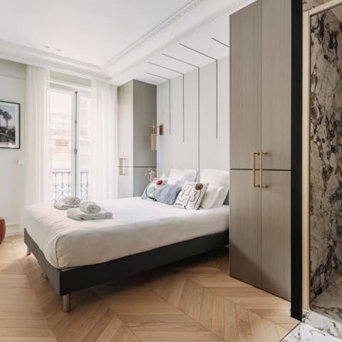 Peer out on Parisian life below from the bedroom's balcony windows