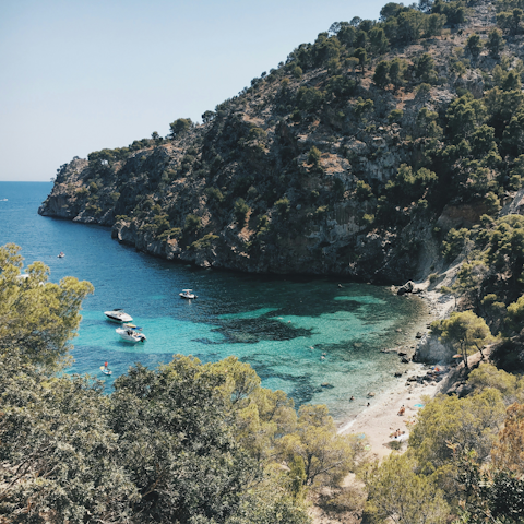 Make the fifteen-minute drive to Cala Blanca