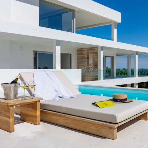 Relax on the patio's day beds with a glass of South African wine in hand