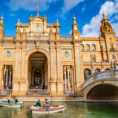 Row a boat along the canal at Plaza de España and admire its beautiful architecture