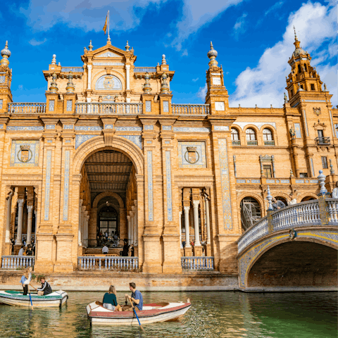 Row a boat along the canal at Plaza de España and admire its beautiful architecture