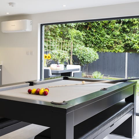 Slide the top off the dining table and play pool instead