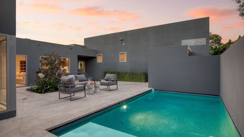 Unwind poolside as the last light fades over the water