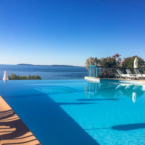 Go for a dip in the shared pool with a stunning sea view