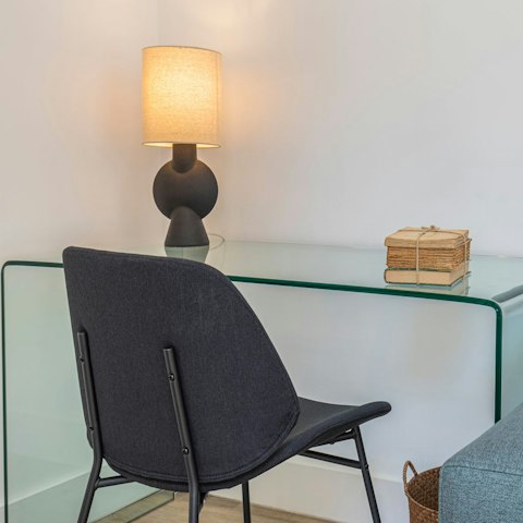 Get down to business at the glass desk in the living area, a sweet spot to work from home