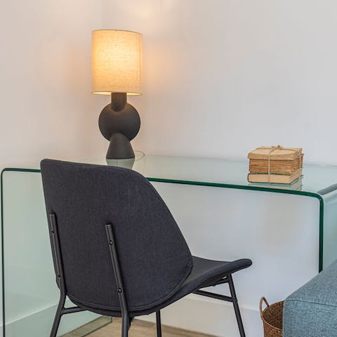 Get down to business at the glass desk in the living area, a sweet spot to work from home