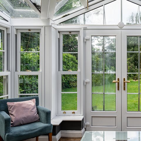 Relax in the conservatory with views of the extensive gardens