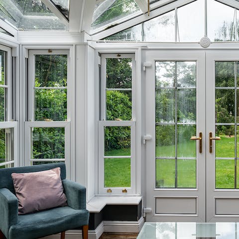 Relax in the conservatory with views of the extensive gardens