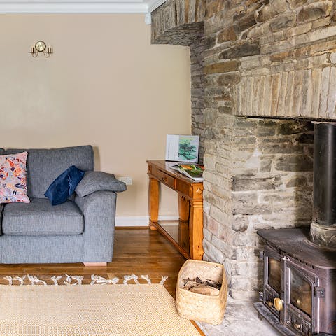Get cosy by the warmth of the fireplace