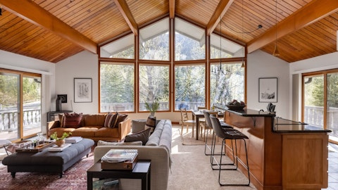 Gather in a light-filled living space framed by mountain views