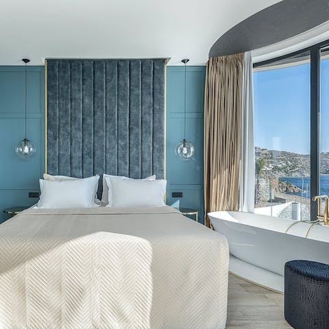 Relax in the in-room, freestanding bath as you take in the sea views