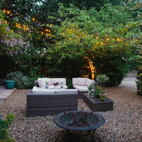 Sip on cocktails in the fairy lit gardens with the fire pit going
