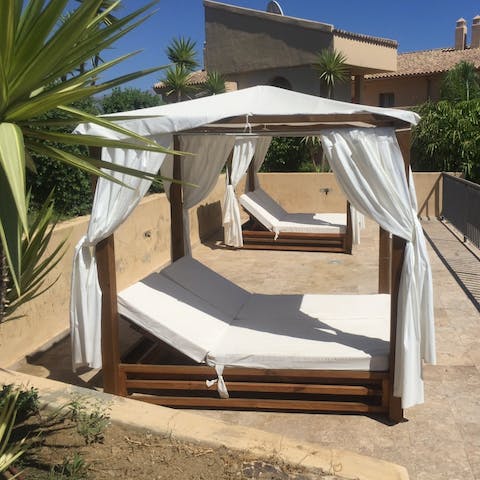 Steal a quiet moment for yourself with a good book on one of the daybeds