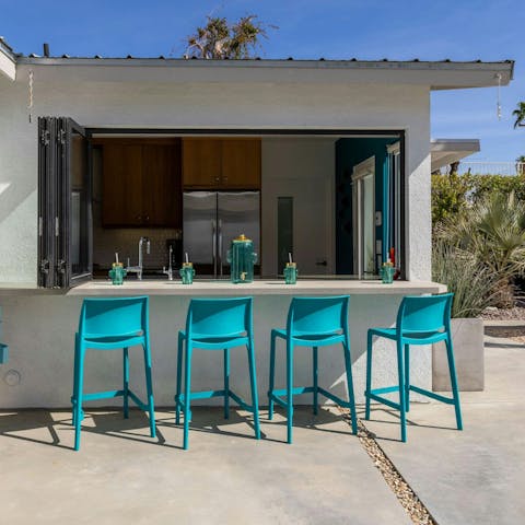 Open up the kitchen windows to create a backyard bar