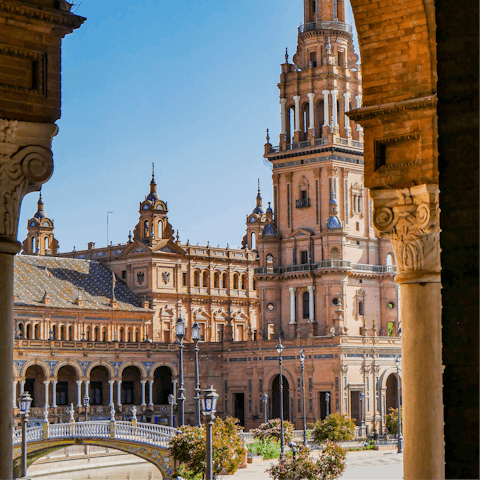 Stroll around the majestic Plaza de España, a bus ride away