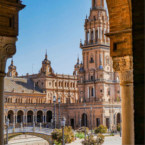 Stroll around the majestic Plaza de España, a bus ride away