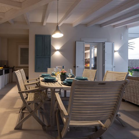 Gather around the outdoor dining table for a barbecue feast of Sicilian produce, while the low-hanging light sets the ambience