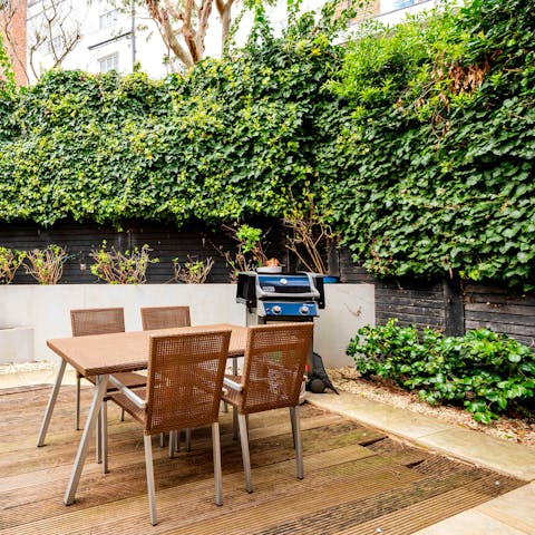 Grill up some dinner on the barbecue while your friends relax at the table (or on the hammock)