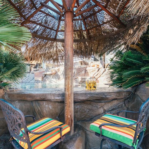 Enjoy a refreshing cocktail at the Tiki Bar