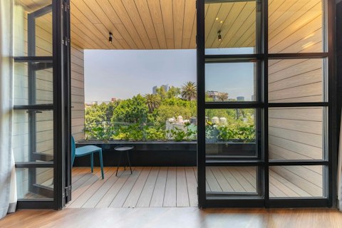 Step out to the balcony with a drink as the city stretches behind