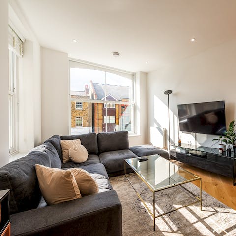 Open up the windows, and listen to the hustle and bustle as you relax on the sofa