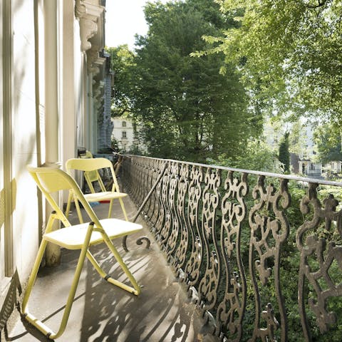 Sip your morning coffee on the balcony overlooking the leafy street
