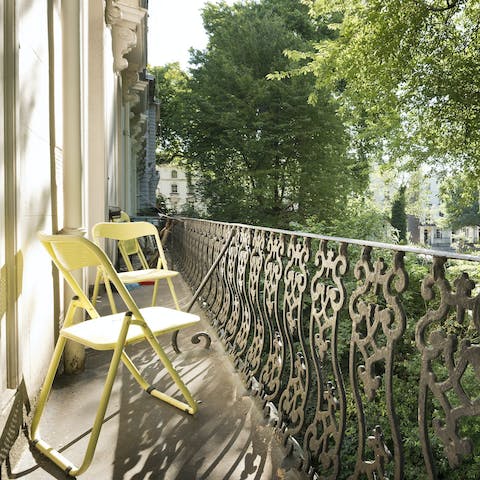 Sip your morning coffee on the balcony overlooking the leafy street