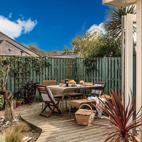 Tuck into an alfresco breakfast before hitting the beach