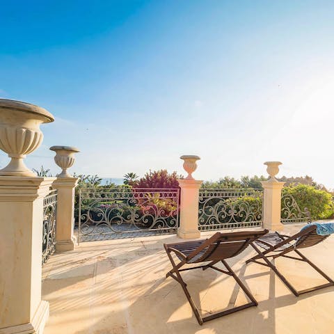 Enjoy early-evening sundowners on the elevated terrace overlooking the garden