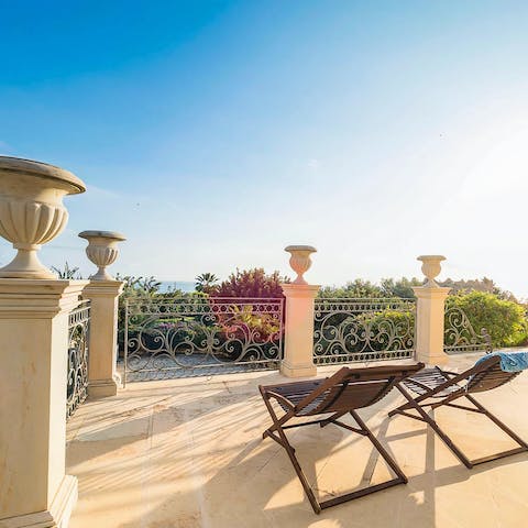 Enjoy early-evening sundowners on the elevated terrace overlooking the garden