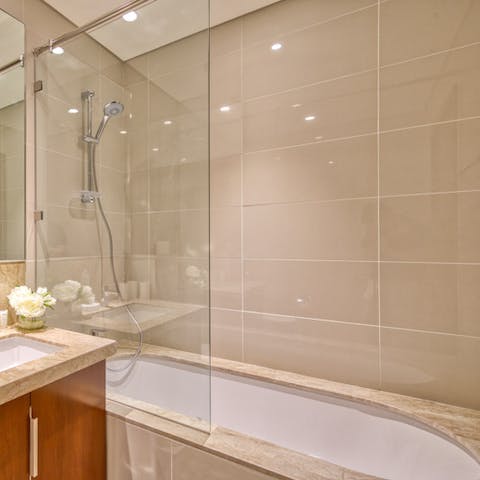 Treat yourself to a restorative soak in the sleek bathtub