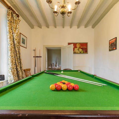 Challenge someone to a round of pool in the game room