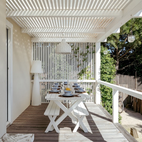 Host alfresco dinners under the chic pergola