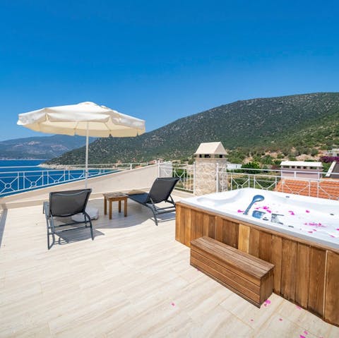 Toast the day's end from the rooftop Jacuzzi