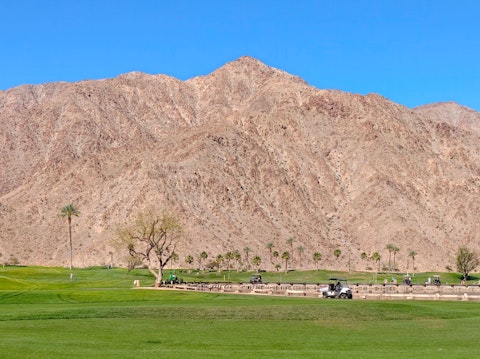 Play championship desert golf framed by spectacular mountain scenery