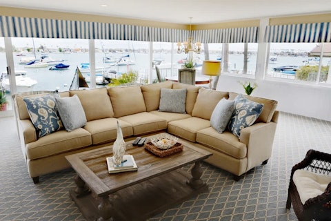 Watch boats drift past from a wraparound waterfront living room