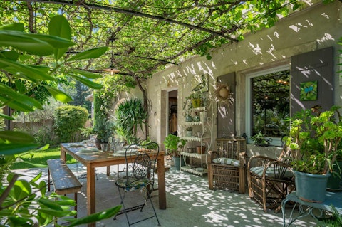 Enjoy a glass of local rosé wine under the vine-covered terrace