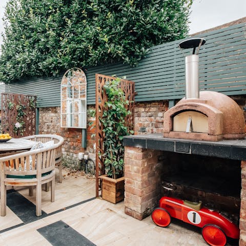 Throw some pizzas in the pizza oven and dine alfresco