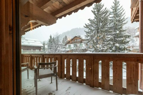 Step out to watch snow fall quietly over the village rooftops