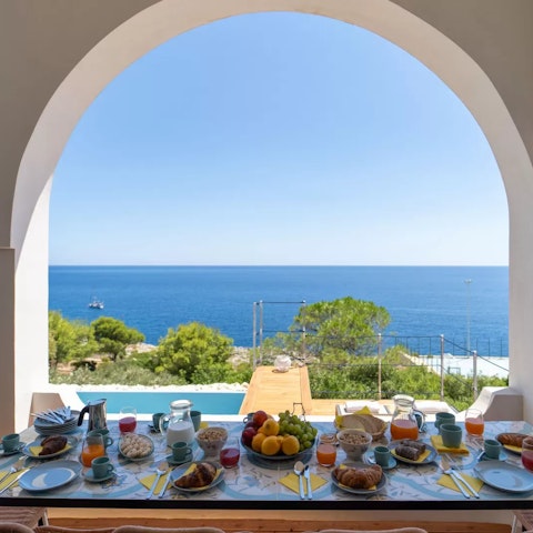 Dine on the terrace, with a framed view of the private pool and ocean