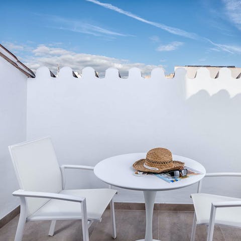 Enjoy a glass of wine with city views on the private rooftop terrace