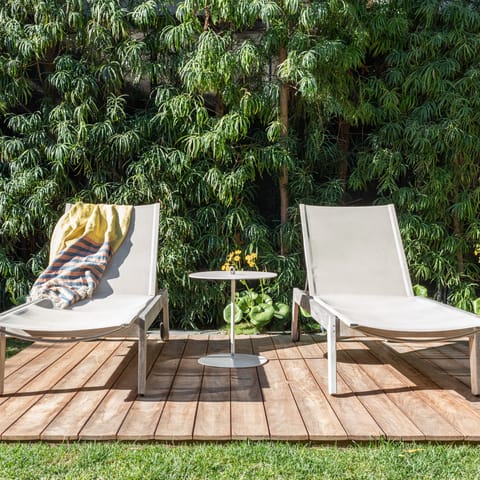 Relax on the deck and enjoy the beautifully landscaped garden with Asian greenery