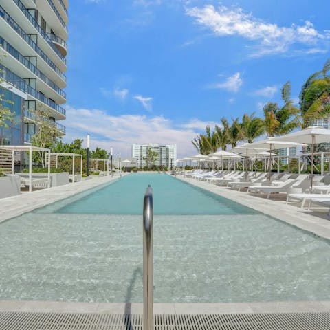 Cool off from the Florida sun in the shared pool surrounded by palm trees