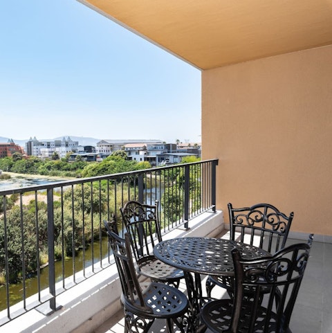 Relax on your balcony with a glass of local wine, overlooking the wetlands and the distant Table Mountain