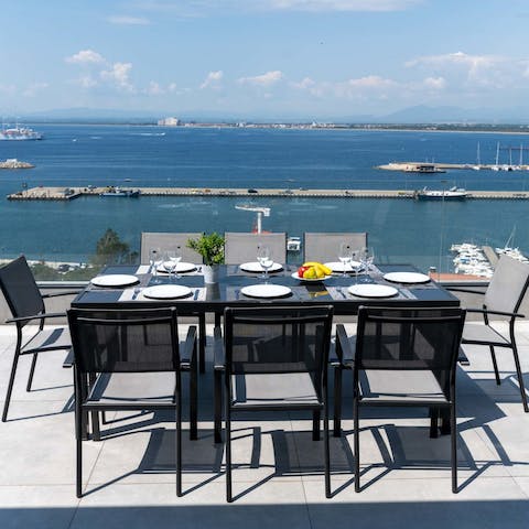 Watch the sun set into the sea as you tuck into dinner